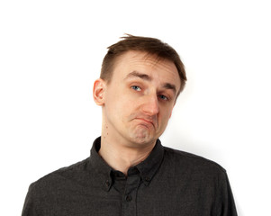 Obraz premium .Young puzzled man portrait on white background