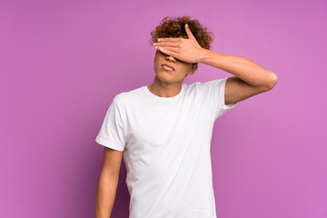 Young african american man over isolated purple wall covering eyes by hands. Do not want to see something