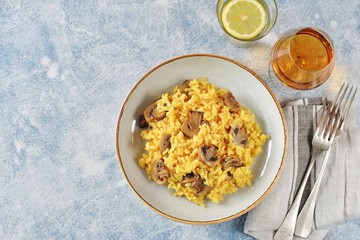 Traditional Italian risotto with  mushrooms, saffron, parmesan cheese, vegetable broth and white wine. Top view. Copy space. 