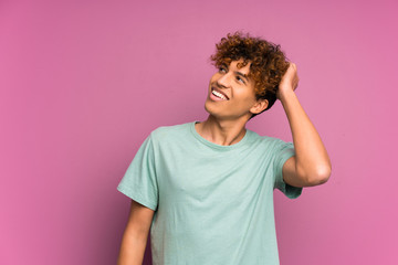 Young african american man over isolated purple wall laughing