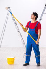 Young handsome contractor working indoors 