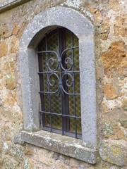 Fototapeta na wymiar A medieval window in a Tuscan hill town village.