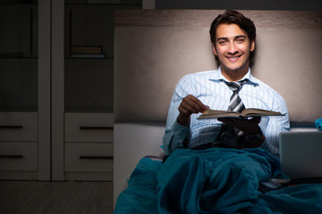 Tired businessman working overtime at home at night