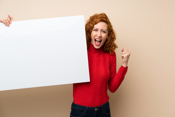 Redhead woman with turtleneck sweater holding an empty white placard for insert a concept