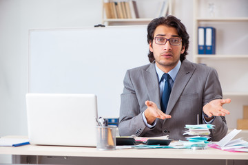 Young handsome businessman in budget planning concept 