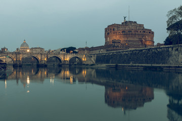 River Tiber in Rome in the background St Peters Cathedral at night. Aurelius Bridge over river with...