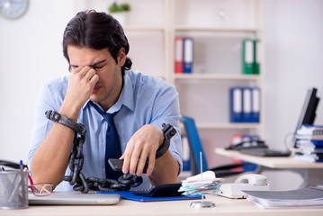 Young male businessman employee unhappy with excessive work  