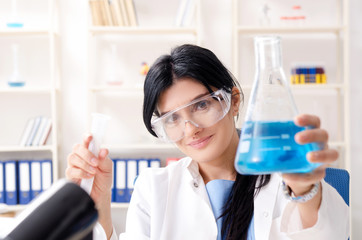 Female chemist working at the lab  