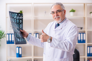 Aged male doctor radiologist in the clinic 