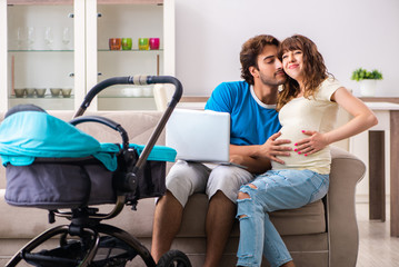 Obraz premium Young parents with baby expecting new arrival