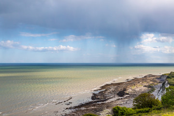 A view out to sea from near Eastbourne in Sussex, with a rain storm on the horizon