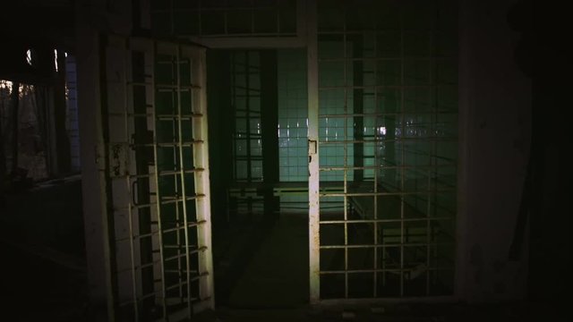 Old abandoned prison cell in the dark