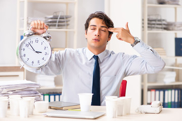 Young employee addicted to coffee