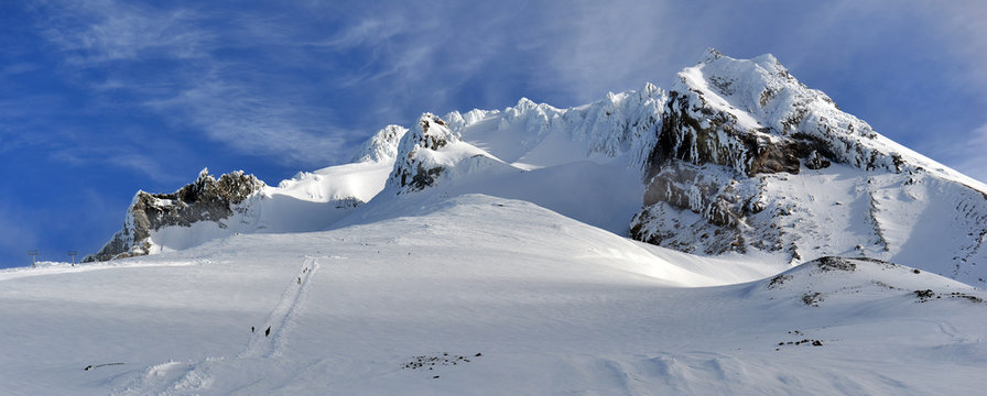 Snow covered terrain on Mount Hood, a volcano in the Cascade Mountains in Oregon popular for hiking, climbing, snowboarding and skiing, despite risks of avalanche, crevasses and weather on the peak.