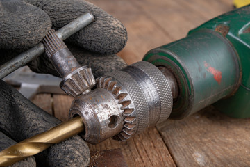 Drilling with a metal drill. Small locksmith work in the home workshop.