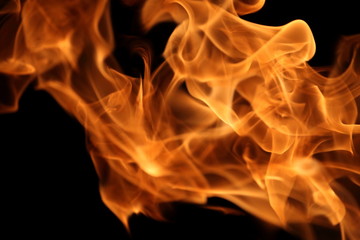 Fire burning on dark background for abstract flame texture and graphic design purpose