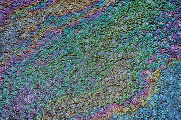 Abstract texture of oil on wet asphalt.