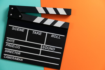 Fototapeta na wymiar movie clapper on color background ; film, cinema and video photography concept