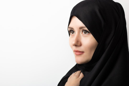 portrait of beautiful muslim woman in hijab on white background in studio with copy space