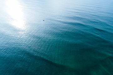 Aerial drone view of beautiful sea wave surface in the sunrise