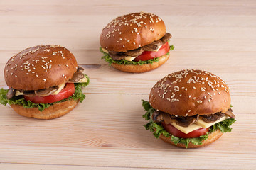homemade cheeseburgers on wooden background, ready meal to eat