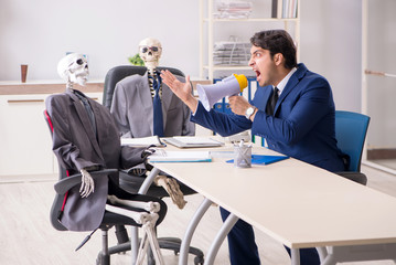 Funny business meeting with boss and skeletons