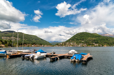 Fototapeta na wymiar Landscape of lake Lugano and Swiss Alps in Lavena Ponte Tresa, province of Varese, Italy