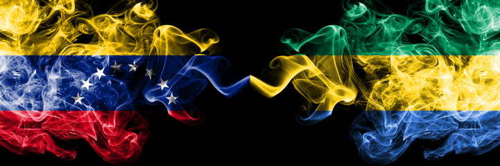 Venezuela vs Gabon, Gabonese smoky mystic flags placed side by side. Thick colored silky smoke flags of Venezuela and Gabon, Gabonese