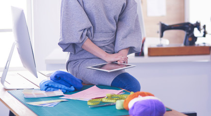 Fashion young designer woman measuring a dress