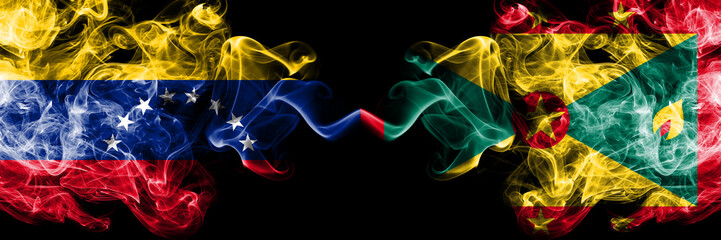 Venezuela vs Grenada smoky mystic flags placed side by side. Thick colored silky smoke flags of Venezuela and Grenada