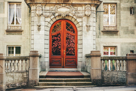 Romantic image of old french facade twith reflection of spring blossoming cherry flowers