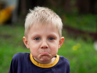 Expressive little caucasian blond boy
