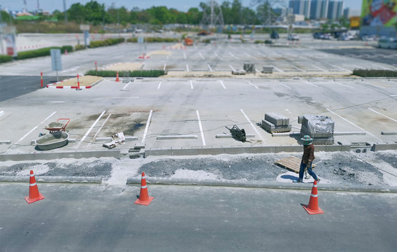 Unrecognizable Construction Worker Working at Parking Lot