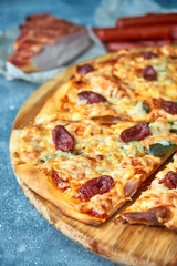 Slice of hot pizza large cheese lunch or dinner crust seafood meat topping sauce. with bell pepper vegetables delicious tasty fast food italian traditional on wooden board table classic in view