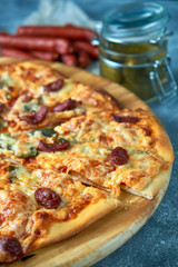 Slice of hot pizza large cheese lunch or dinner crust seafood meat topping sauce. with bell pepper vegetables delicious tasty fast food italian traditional on wooden board table classic in view