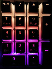 macro mechanical keyboard rgb keys illuminated in a dark room gaming esport gear © filiz