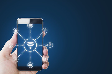 Mobile phone Internet wireless and application technology. Hand holding mobile smart phone and WiFi and application icons