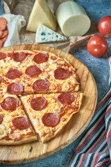 Slice of hot pizza large cheese lunch or dinner crust seafood meat topping sauce. with bell pepper vegetables delicious tasty fast food italian traditional on wooden board table classic in view