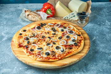 Slice of hot pizza large cheese lunch or dinner crust seafood meat topping sauce. with bell pepper vegetables delicious tasty fast food italian traditional on wooden board table classic in view