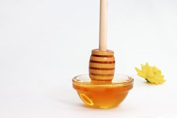 wooden honey stick in a small Cup