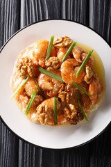 Crunchy shrimp with honey, candied walnut, and sweet mayo close-up. Vertical top view