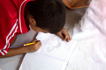 boy drawing cartoon on floor