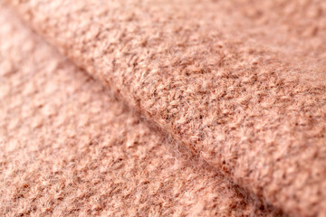 ピンクベージュの模様編みのニット地