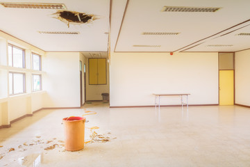 water leak drop in red tank interior office building in from ceiling and flow on terrazzo floor
