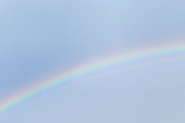 Fototapeta premium view on rainbow in a blue sky