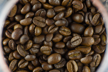 Close-up view of coffee beans in a glass glass glass. Horizontal photography