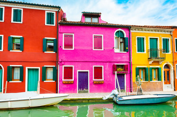Fototapeta na wymiar Colorful houses on the canal in Burano island, Venice, Italy