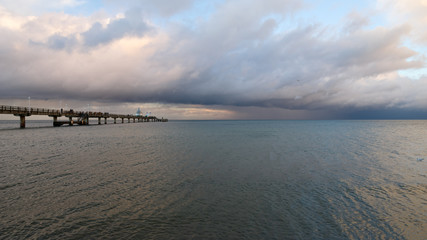 Sea bridge at the Baltic Sea against a dramatic sky with clouds 
