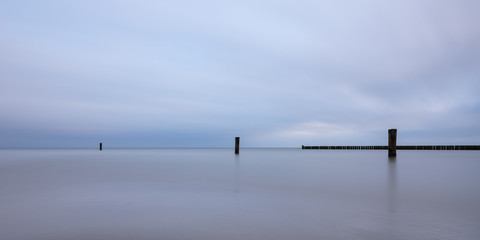 Long exposure at the Baltic Sea against dramatic blue sky