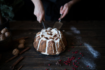 Christmas baking. Cooking homemade cake at home rustic kitchen. Woman's hands. Ingredients for cooking christmas baking on dark wooden table. Holidays, winter, Christmas concept. Soft focus.